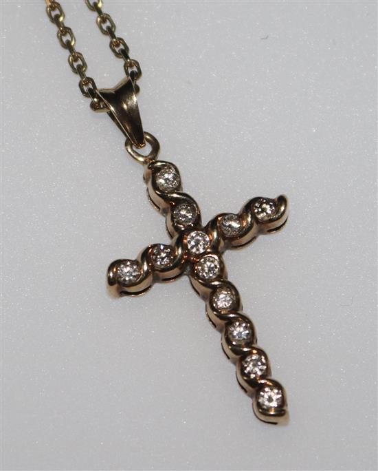 A 9ct gold and diamond set cross pendant on a 9ct gold chain, pendant 1in.